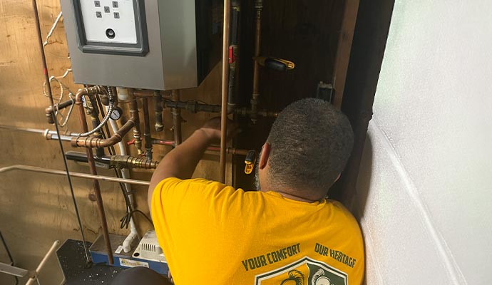 A professional of Heritage Heating and Air repairing water heater