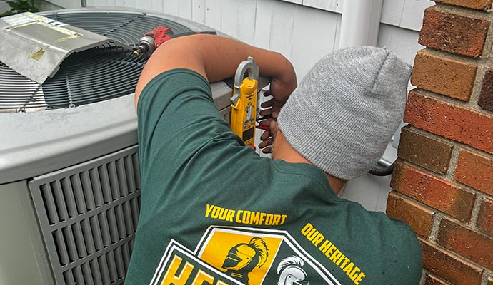 A technician is testing an outdoor AC unit