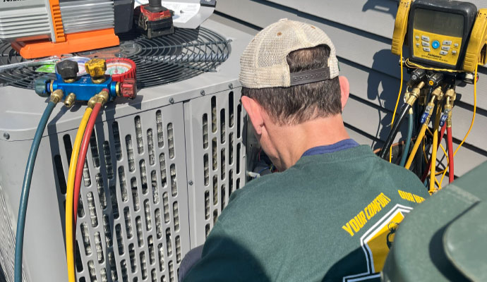 Heritage Heating and Air technician checking HVAC system