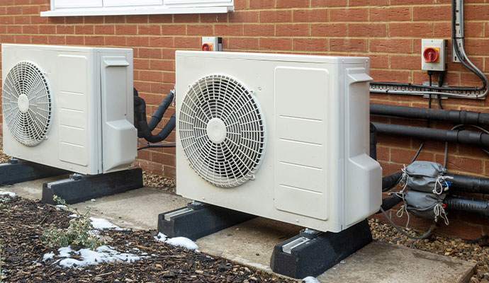 Two white slim-profile AC condenser units