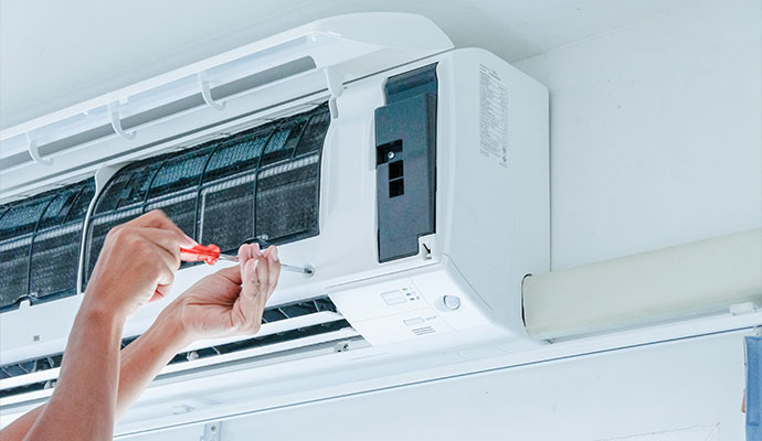 Technician servicing indoor mini-split unit