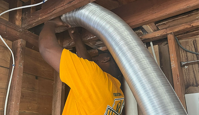 Technician installing duct