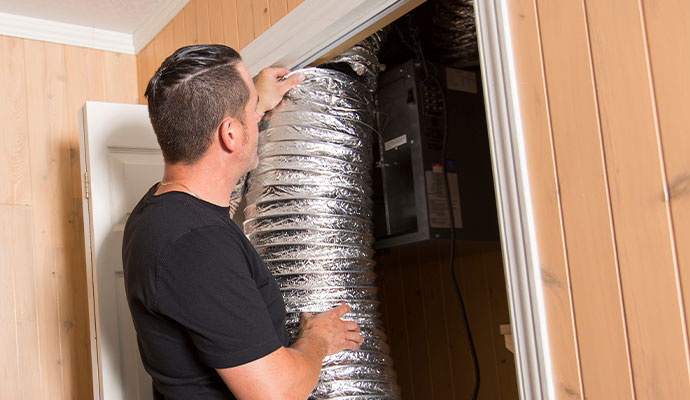 Technician inspecting insulated flexible ducting