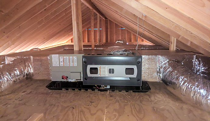 A furnace in an attic after replacement