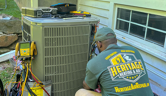 Heritage Heating and Air technician repairing HVAC unit
