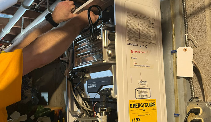 Technician installing heating system