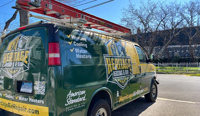 Heritage Heating and Air service van with ladder on top