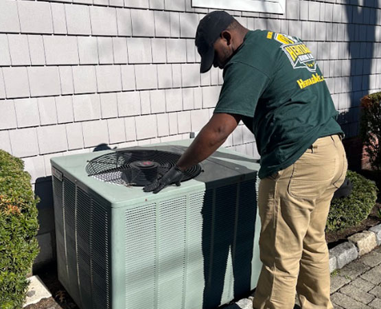 HVAC technician inspecting outdoor ac
