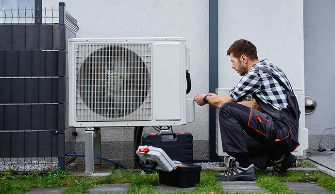 Technician servicing an outdoor mini-split unit