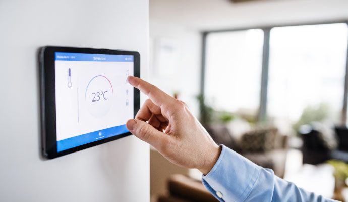 Person touching smart home temperature display