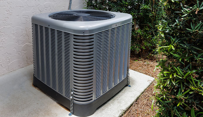 Outdoor air conditioning condenser unit on concrete pad