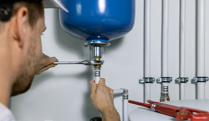 Technician installing expansion tank