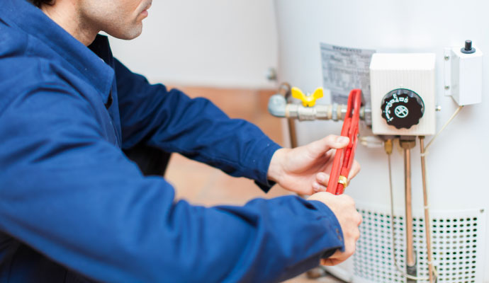 Technician repairing water heater