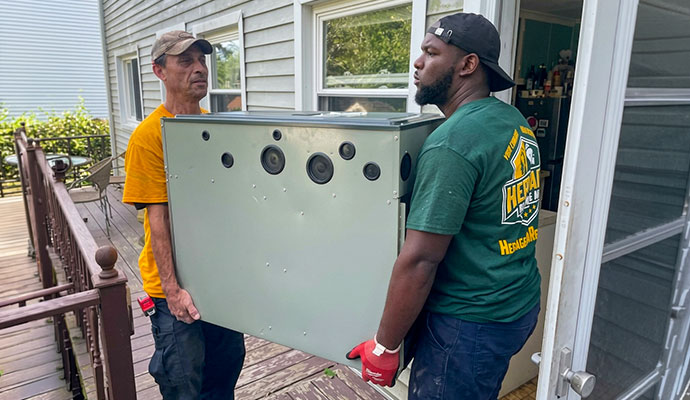 Technicians are carrying a furnace