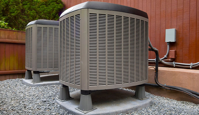 Two outdoor central air conditioning compressor units